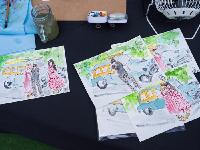 Finished watercolor sketches and paint supplies on the table at one of Teresa Cook&rsquo;s live painting sessions